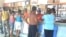 Residentes hacen fila para adquirir alimentos racionados en una bodega de Holguín. 