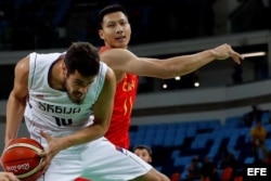 El serbio Nikola Kalinic (i) protege el balón ante la marca del chino Jianlian Yi (d) en Río.